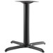 A Lancaster Table & Seating black metal table base with a black cross and pedestal.