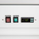 The white customizable panel with two electronic controls for an Avantco glass door merchandiser freezer.