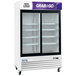 An Avantco white sliding glass door refrigerator for merchandising.