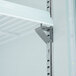 The side of a black Avantco Glass Door Merchandiser Freezer with a metal bracket.