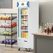 An Avantco white glass door merchandiser freezer with shelves full of food.