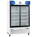 An Avantco white sliding glass door merchandiser refrigerator with LED lighting on wheels.