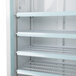 A white Avantco swing glass door refrigerator with shelves.