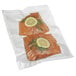 Two pieces of salmon with lemon slices in a Hamilton Beach vacuum seal bag.