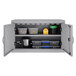 A gray Hirsh Industries wall mount upper cabinet with a few plastic containers and a white box on the shelf.