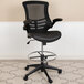A Flash Furniture black mesh drafting stool with leather seat and metal base.