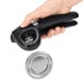A person using a black OXO Good Grips handheld can opener to open a can.