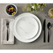 An American Metalcraft matte white melamine bouillon cup on a table with a plate and fork.
