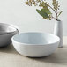 Three white American Metalcraft Cloud melamine bowls on a table.