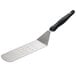 A Vollrath stainless steel turner with a black handle.