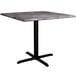 A Lancaster Table & Seating square dining table with a black base and gray top.