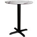 A round Lancaster Table & Seating table with a white marble top and black cross base.