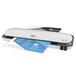 A white and blue Royal Sovereign laminator with blue and white paper.