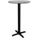 A Lancaster Table & Seating Excalibur round bar table with a grey textured top and black base.