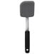 An OXO black and white silicone cookie spatula with a black handle.