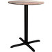 A round Lancaster Table & Seating Excalibur counter height table with a black cross base plate.