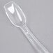A 0.5 oz. clear plastic topping dispenser spoon with a handle.