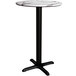 A Lancaster Table & Seating round counter height table with a white marble top and black cross base.