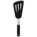 An OXO black silicone slotted spatula with a silver handle.
