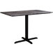 A Lancaster Table & Seating rectangular dining table with a black base and smooth marble top.