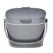 An OXO charcoal gray plastic compost bin with a handle.
