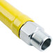 A yellow gas hose with silver metal fittings.