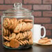 A Choice glass jar full of cookies with a glass lid.