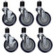 A set of six black and grey casters with rubber wheels.