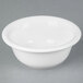 A Tuxton white china pot pie bowl on a gray surface.
