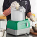 A person using an AvaMix commercial food processor to shred cheese.