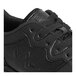 A close up of a black Genuine Grip men's athletic shoe with a lace.