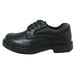 A close up of a black leather Genuine Grip women's oxford shoe with laces and a rubber sole.