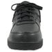 A close-up of a black Genuine Grip Sport Classic shoe with laces.