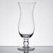 An Anchor Hocking footed hurricane cocktail glass with a clear base.