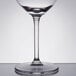 A Libbey wine glass with a clear bowl and stem and a white rim.
