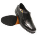 A pair of black leather Genuine Grip men's slip-on dress shoes with a black rubber sole.