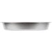 A close-up of a Vollrath stainless steel round food pan with a round rim on a white surface.