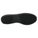 The black rubber sole of a Genuine Grip black leather athletic shoe.