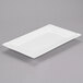 A white rectangular porcelain platter with a scalloped edge.