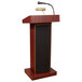An Oklahoma Sound mahogany lectern with microphone and speaker.