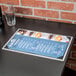 A Menu Solutions brushed aluminum menu board with picture corners on a table.