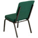 A green church chair with a gold vein frame and dot pattern.