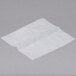 Durable Packaging interfolded deli wrap wax paper on a white surface.