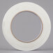A roll of Shurtape white fiberglass strapping tape with a clear circle on the roll.