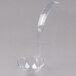 A clear plastic ladle with a long curved handle.