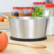 A Vollrath stainless steel tapered sauce pan on a counter.