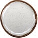 A white melamine plate with brown speckled dots.