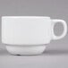 A close-up of a Tuxton bright white espresso cup with a handle.