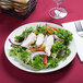 A Tuxton Venice ivory china plate with chicken salad and vegetables on it.