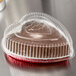 A clear plastic dome lid on a heart shaped foil bake pan.